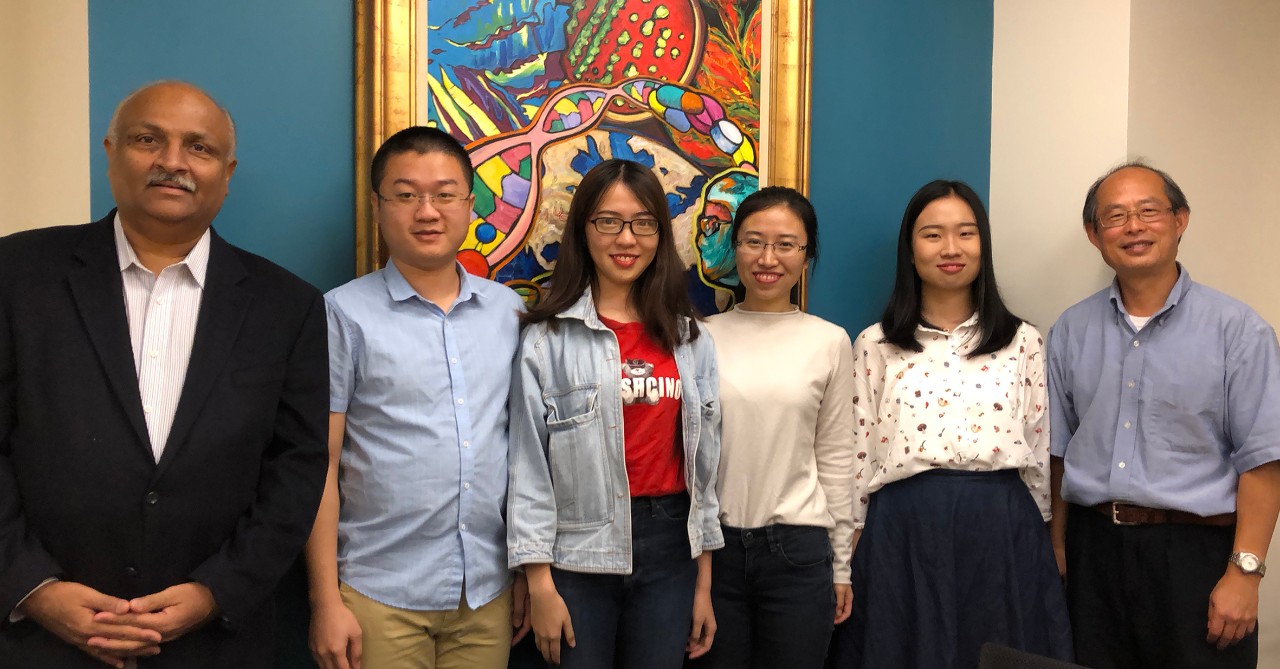 The four Xiamen University MSDD students pose with two professors