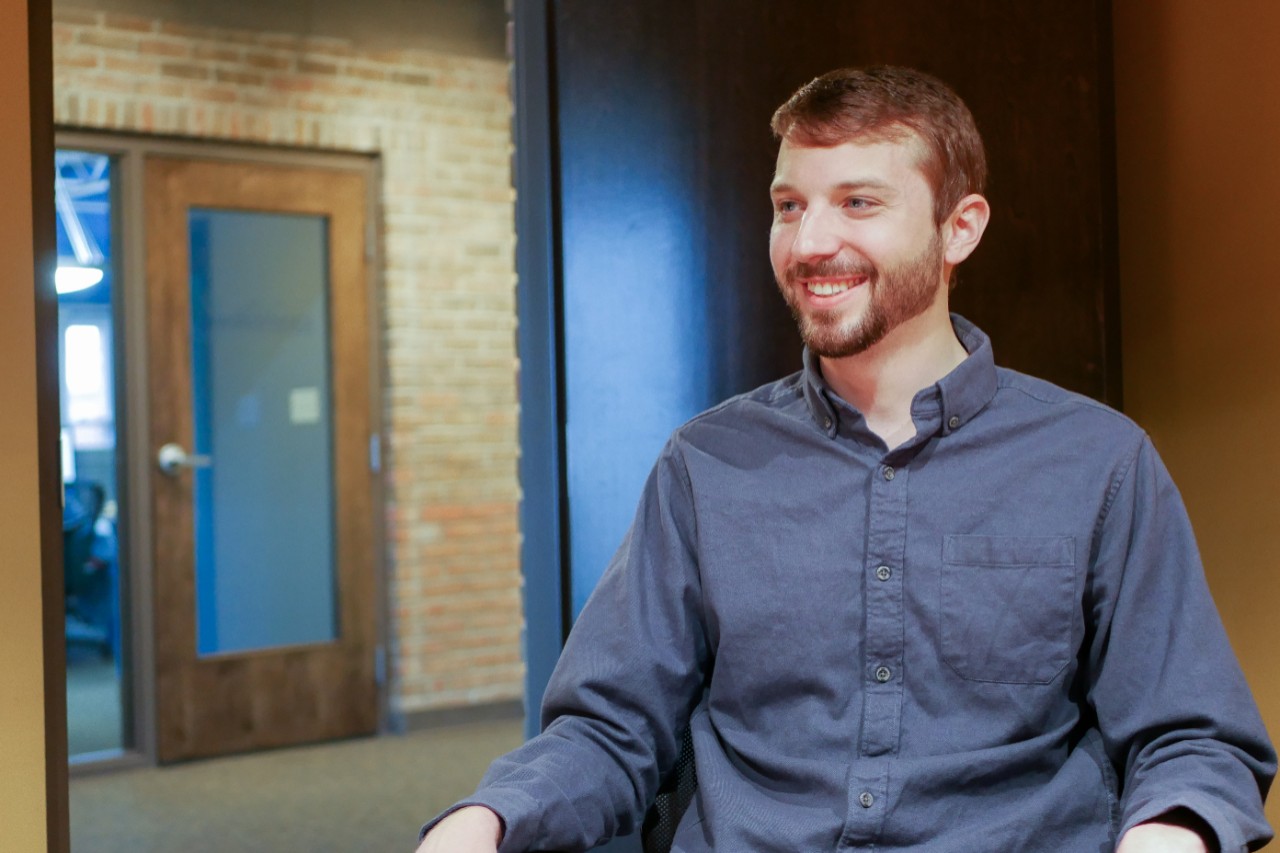 Buzza smiling in office