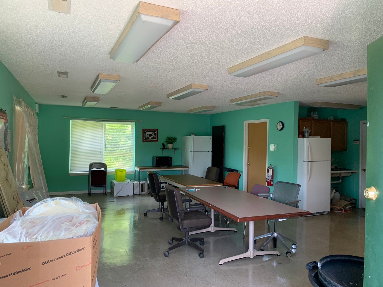 A cleaned room with tables and boxes.