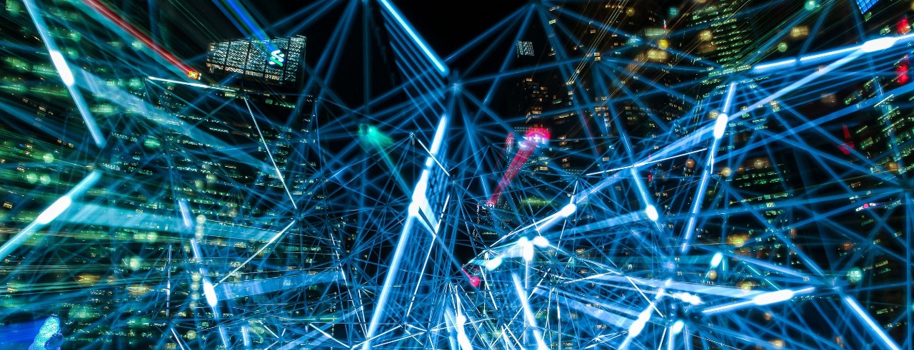 Night-time cityscape with streaks of light crossing in front