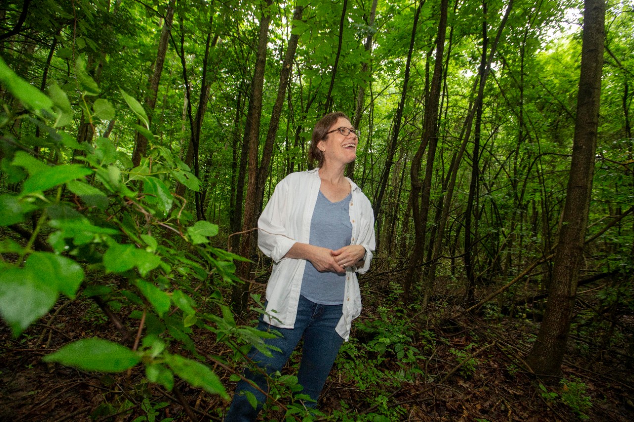 Theresa Culley, UC biology professor shown here with invasive Bradford or Callery pear trees at Harris benedict Nature Preserve in Hazelwood, Ohio.  UC/Joseph Fuqua II
