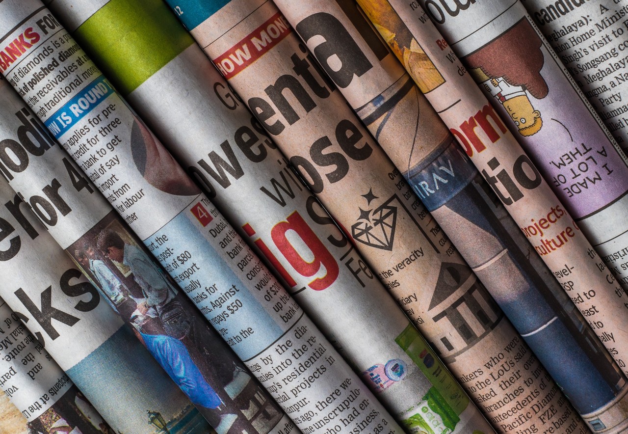 A stack of folded newspapers.