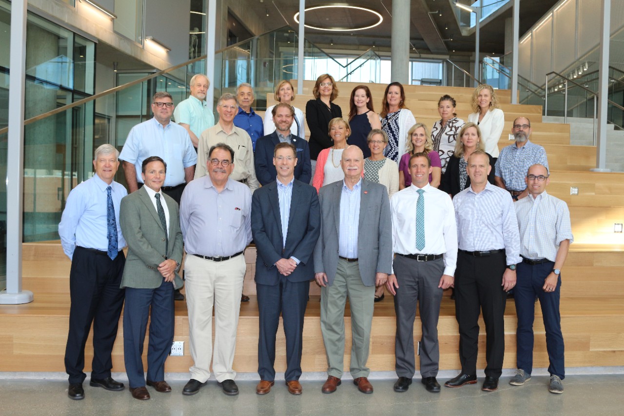 Members of the Association of Schools of Allied Health Professions Midwest Deans gather on the stairs of the Health Sciences Building.