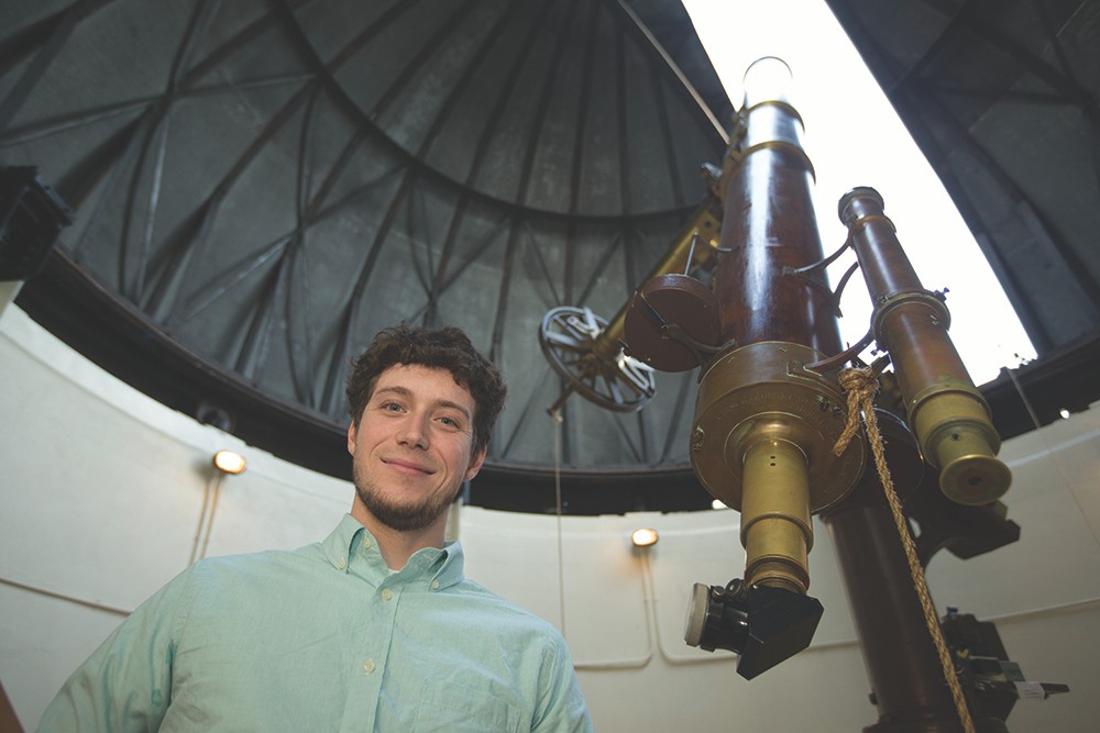 UC graduate Kevin Wagner at the Cincinnati Observatory. Wagner, an astrophysicist, discovered Scorpion-1b, a planet with three suns, last year at the European Southern Observatory in Chile. His discovery is expected to help astronomers refine theories about how new planets are formed. Wagner is a graduate of the McMicken College of Arts & Sciences.