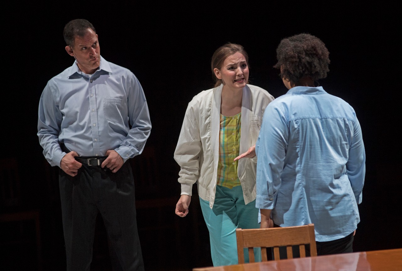 Three actors on stage as Nancy Smith pleads with someone