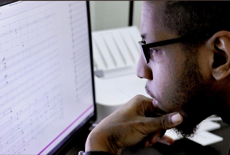 UC CCM Brian Nabors studies his music composition on a computer screen.
