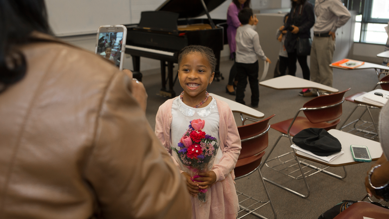 A proud parents taking a photo of their CCM Prep student after a performance.