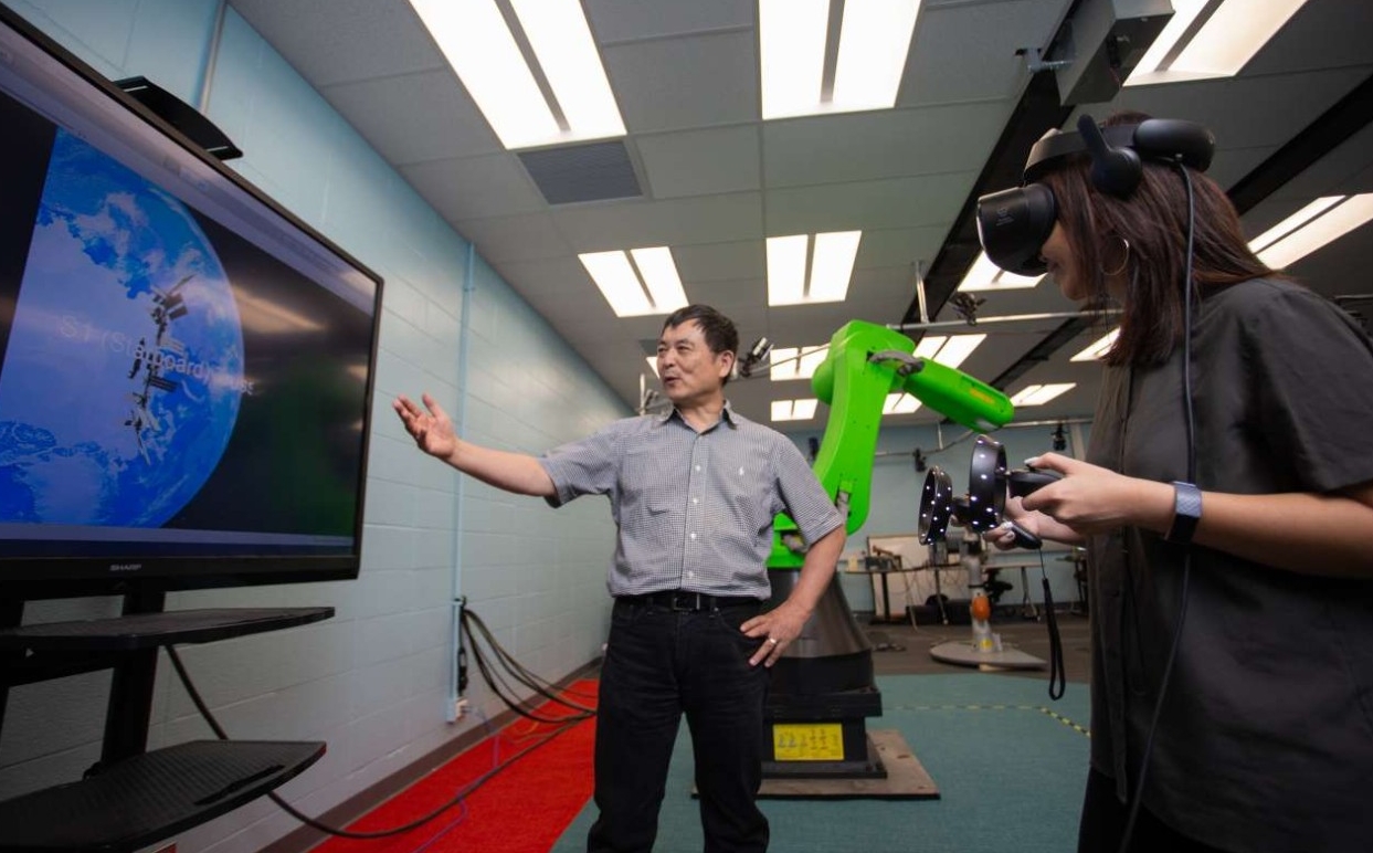 Ou Ma supervises an augmented reality demonstration in his robotics lab.