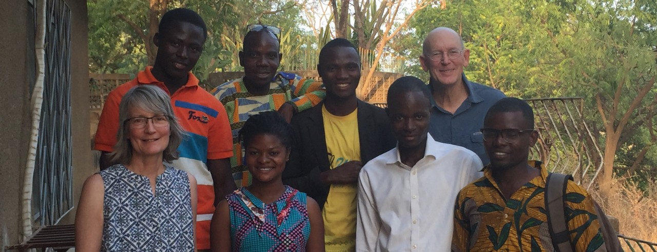 Mary Rudemiller standing with several people helped out by the Ghana Health Mission.