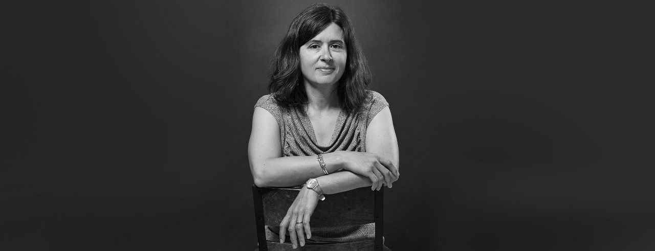 a woman sits in a chair