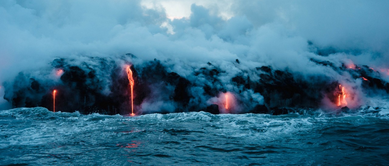 Lava pours into the ocean.