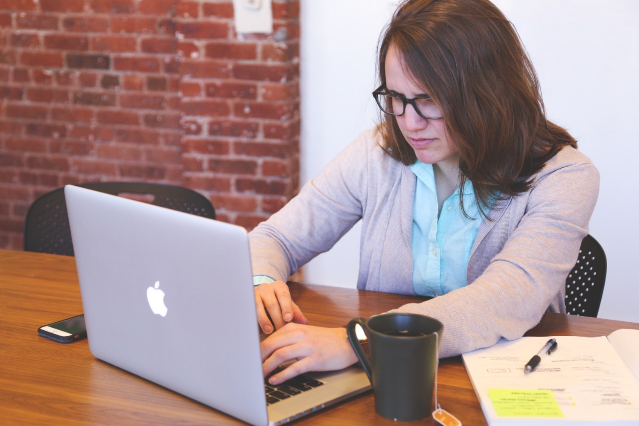Woman works on her laptop.