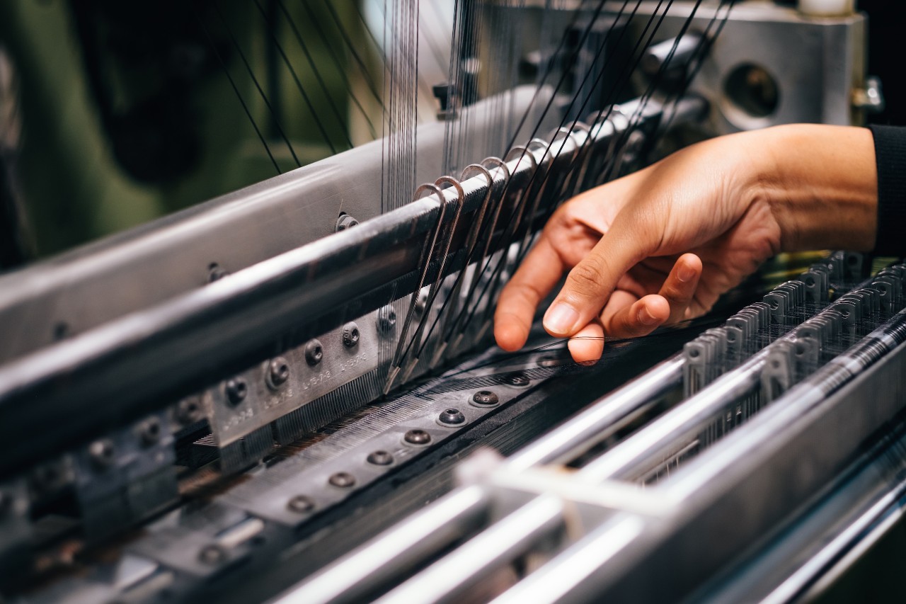Close up of a hand working on a machine