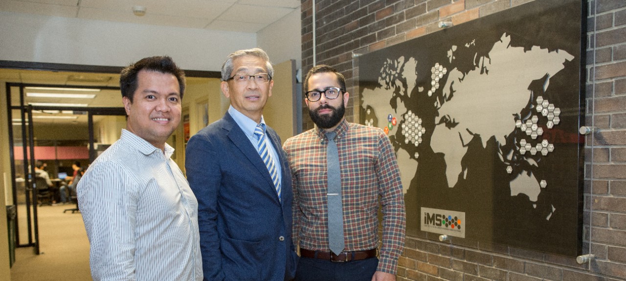 Edzel Lapira, Jay Lee and Patrick Brown stand in front of Lee's lab.