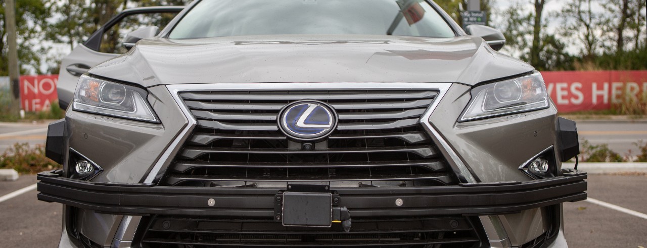 A closeup of the sensors on the bumper of a Lexus hybrid SUV that UC is using for its driverless car research.