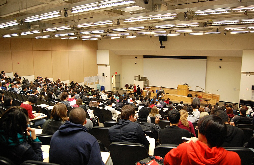 Conference attendees listen to lecture.