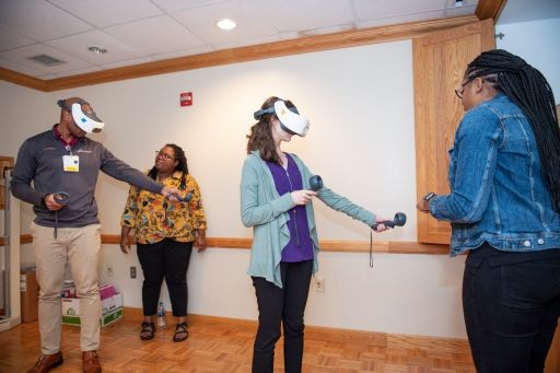 two people wearing VR equipment being trained in a room