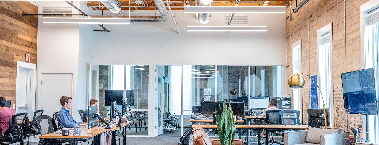 Small, modern office with four workers on computers