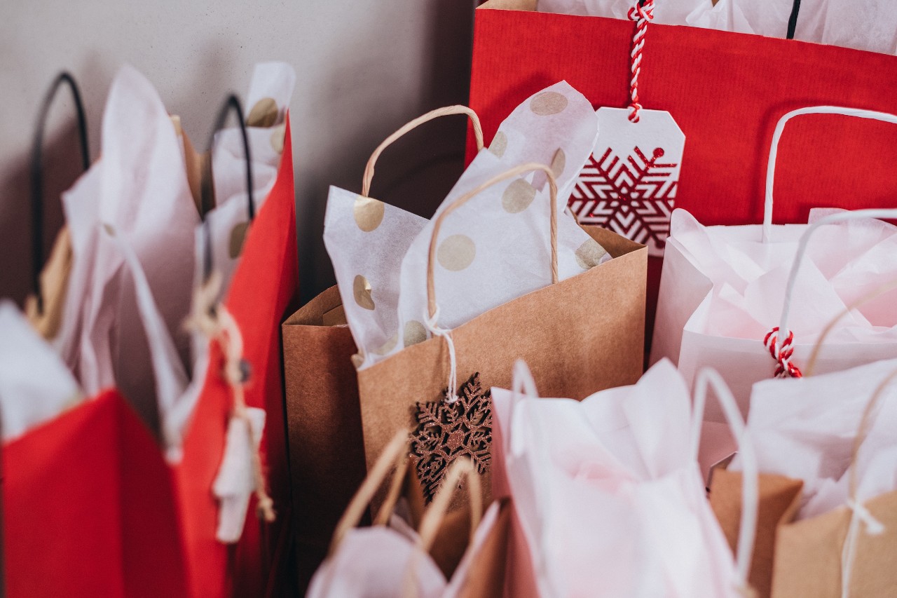 several paper bags with tissue paper coming out of the top