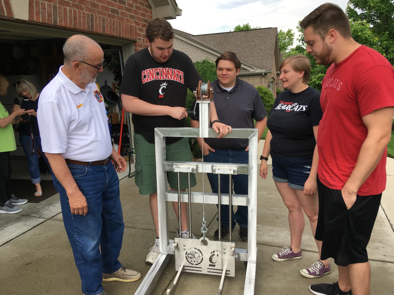 UC students delivering the winch they designed and built.