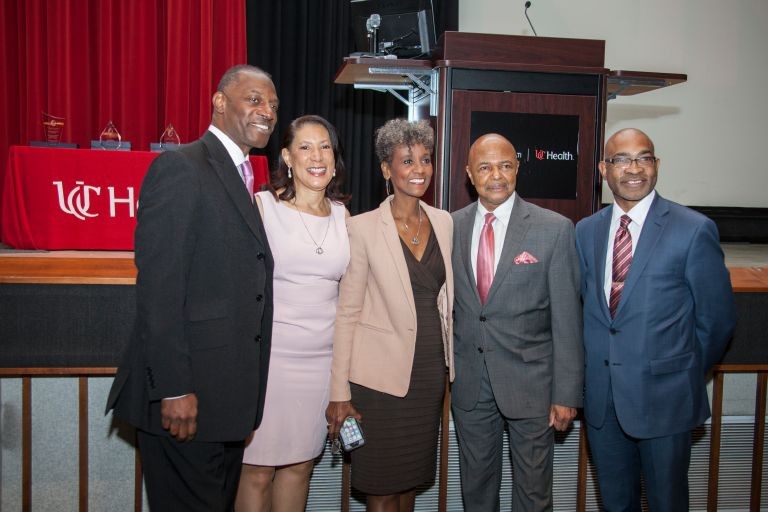 picture of three humanitarian award winners at MLK event with keynote speaker and master of ceremony