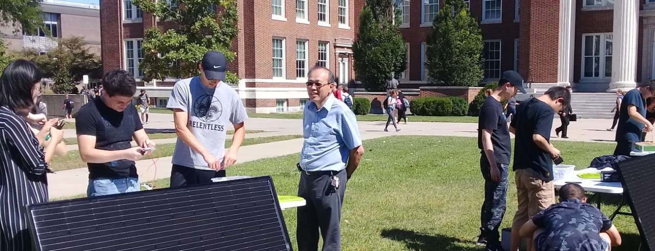 Students work on solar energy systems outside during a lab for a new solar energy course.