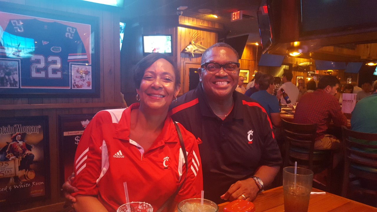 man and woman wearing UC shirts