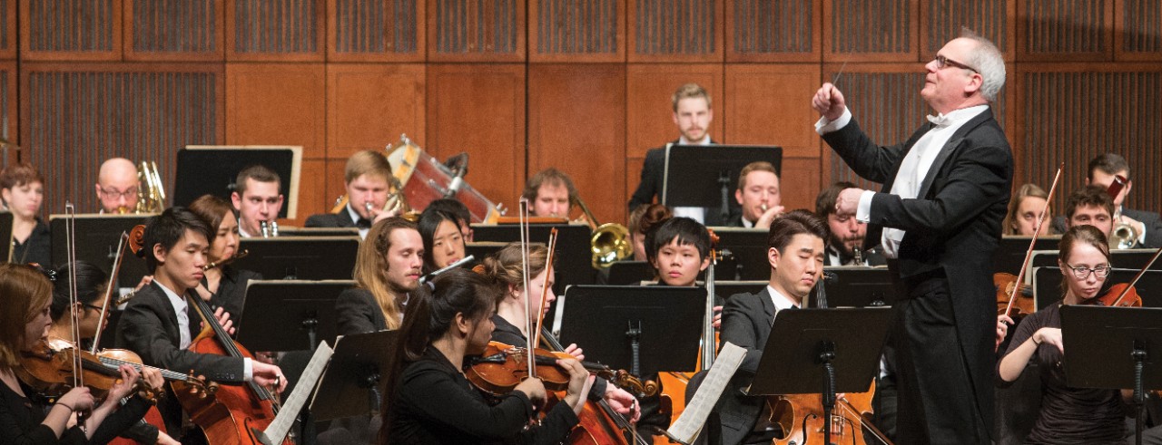 Students in the CCM Philharmonia rehearsing on stage in Corbett Auditorium.
