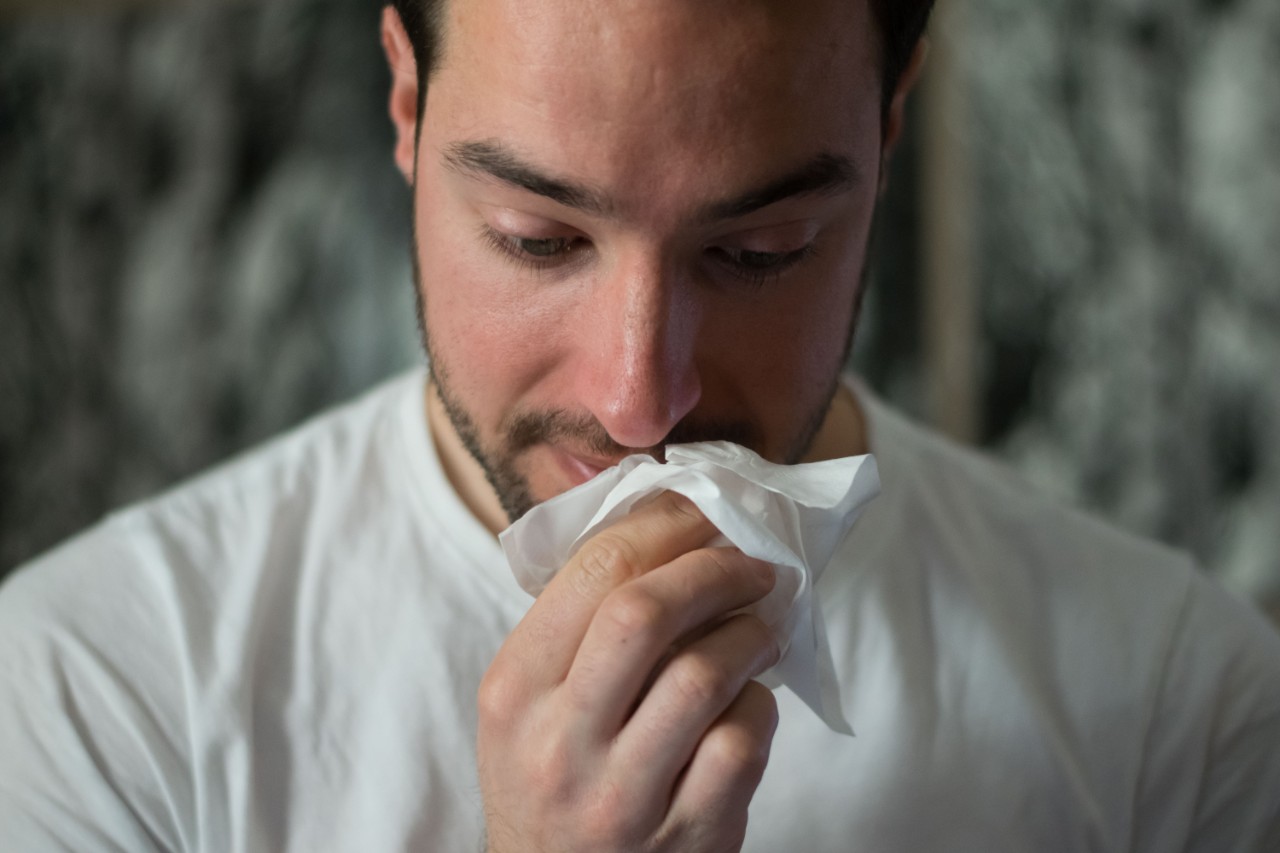 photo of man blowing his nose