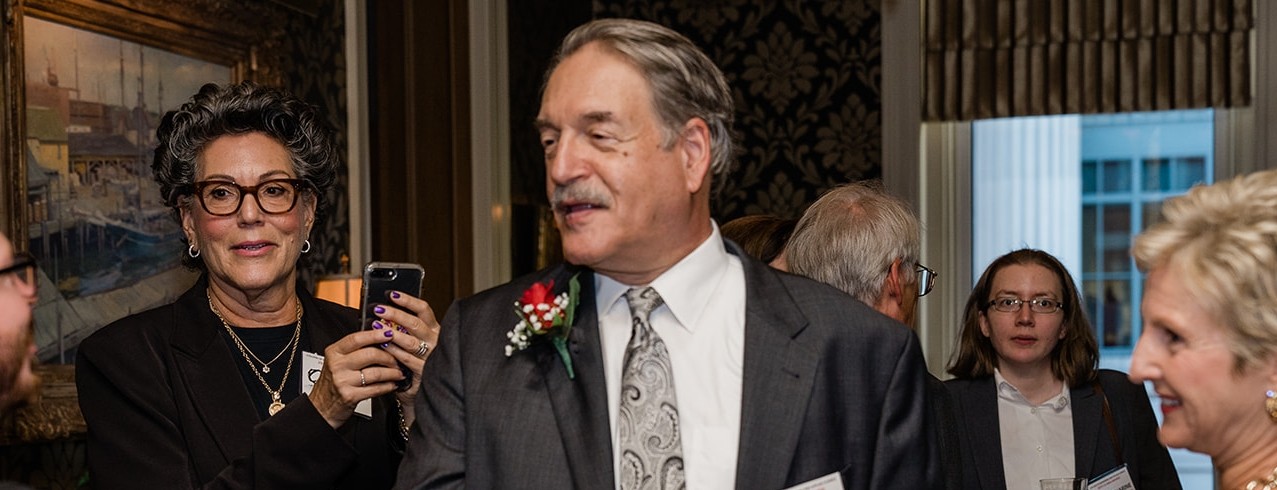 Lew Soloway greets people at the CEAS alumni awards event.