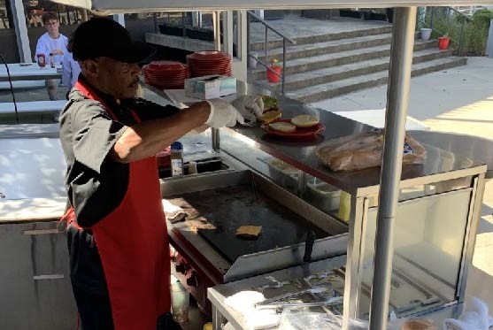 Chef grilling food on MarketPointe patio