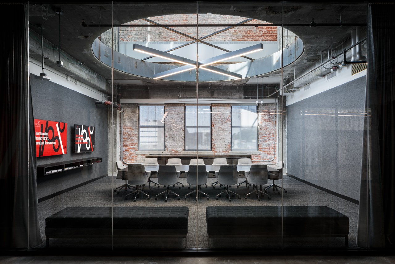 A conference room with a circular opening in the ceiling