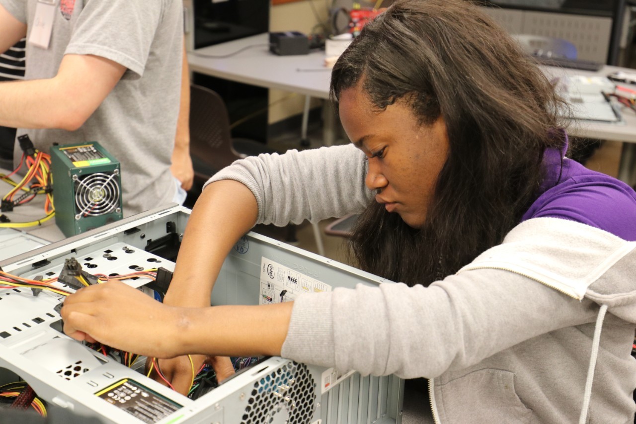 A student replaces a computer processor.