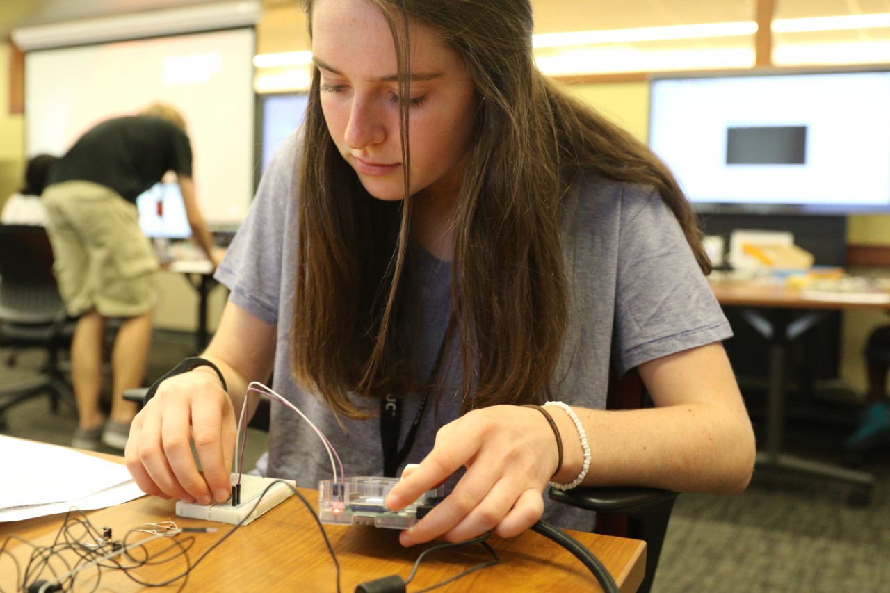 A high school student works with electronics.