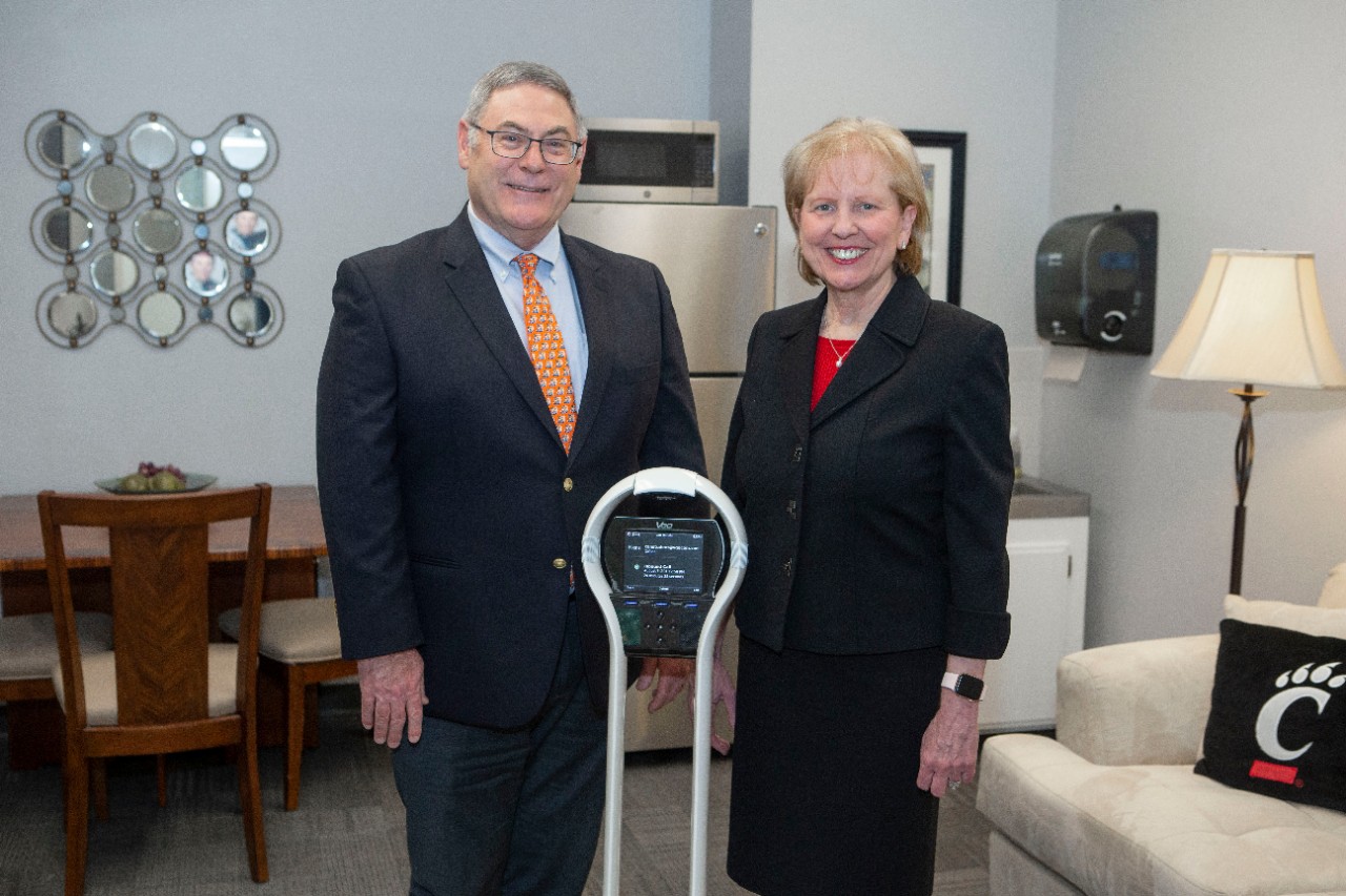 Left to right Chuck Doarn and Dr. Debi Sampsel, DNP Director of Smart House posed the V-go robot at MapleKnoll. UC/ Joseph Fuqua II