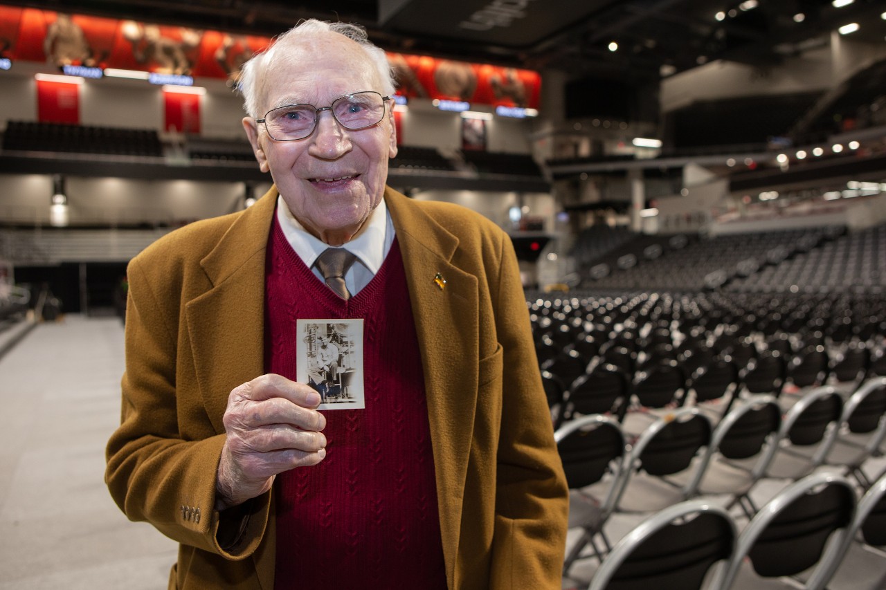 Paul Blom holds a photo of himself from the military