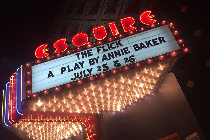 A movie theatre marquee displays the showing for "The Flick."