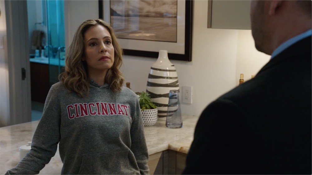A woman and a man stand in a kitchen
