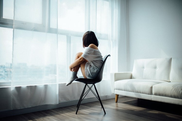 child sitting alone on chair