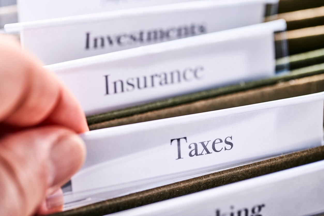 TAXES: Files and folders in desk drawer with labels and tabs: Home office management