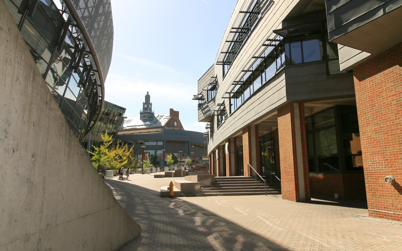 A long path with large buildings on either side