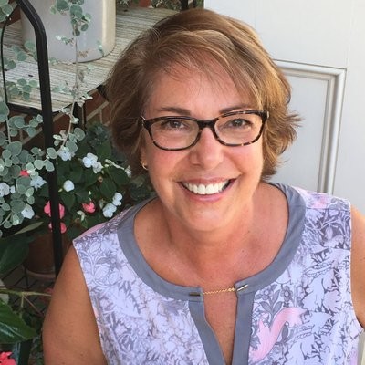 Woman wearing glasses with a purple shirt