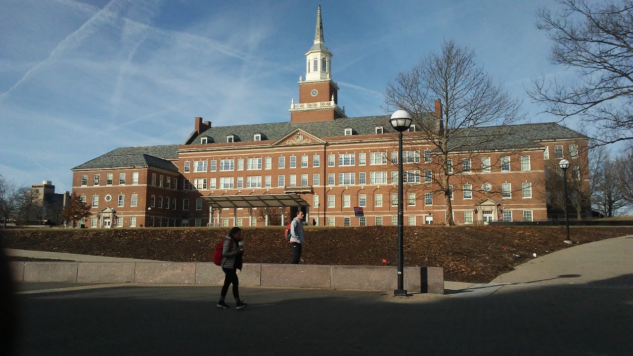 The McMicken College of Arts and Sciences stands tall against a blue sky.