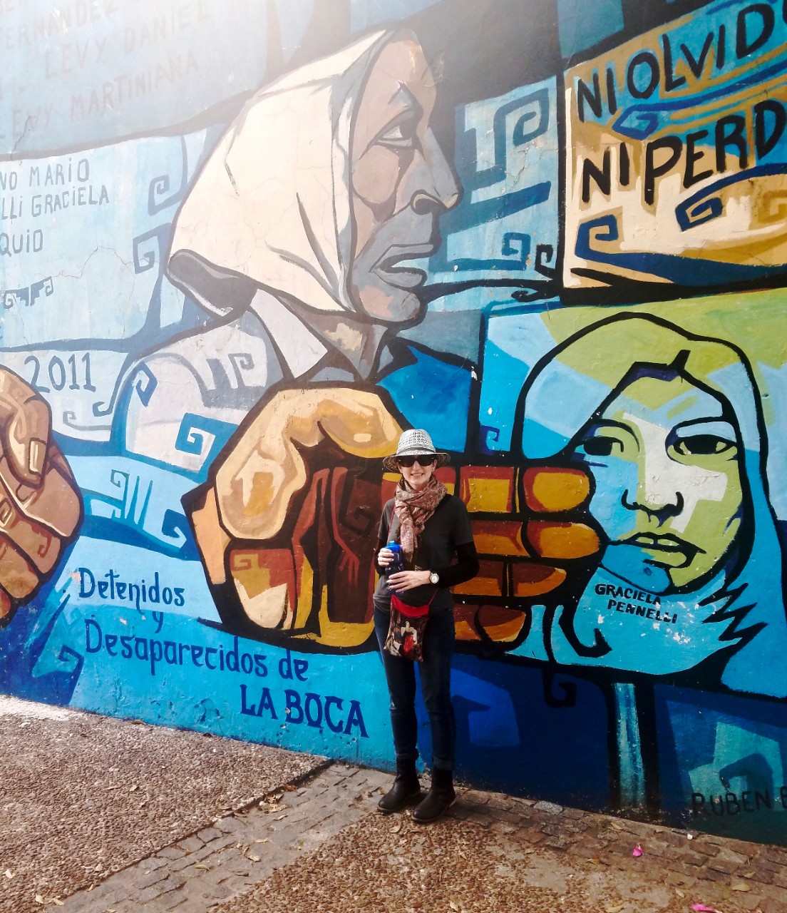 UC's Crystal Whetstone stand s in front of a wall mural in Argentina.