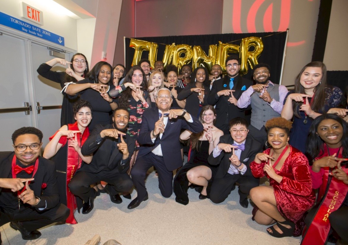 UC's Darwin T. Turner program members all together on a stage.