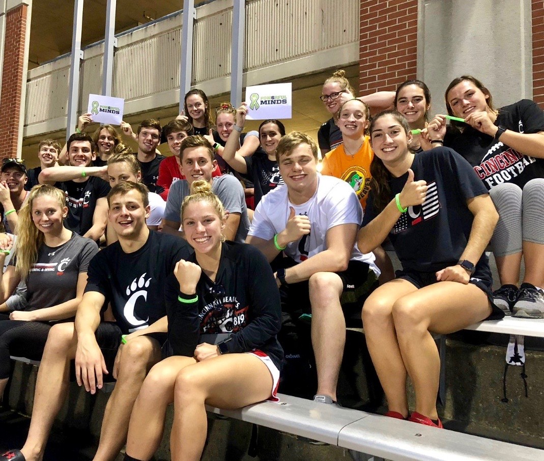 UC's Din Selmanovic sits in the Fifth Third Arena with several members of the Pow6rfulMinds organization.