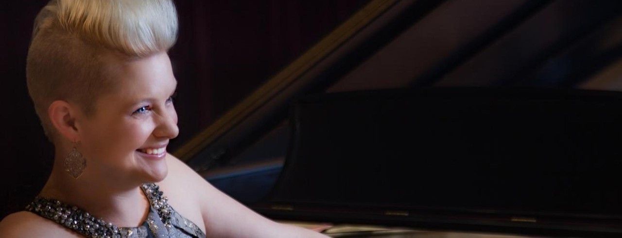 Danielle Cozart Steele smiles while at a piano