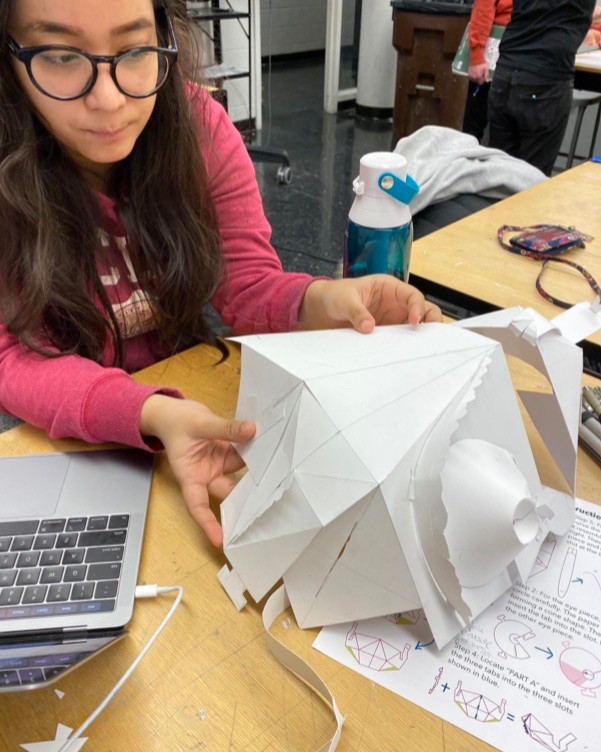 UC's Reeha Das holds a 3D paper model in a DAAP design lab.