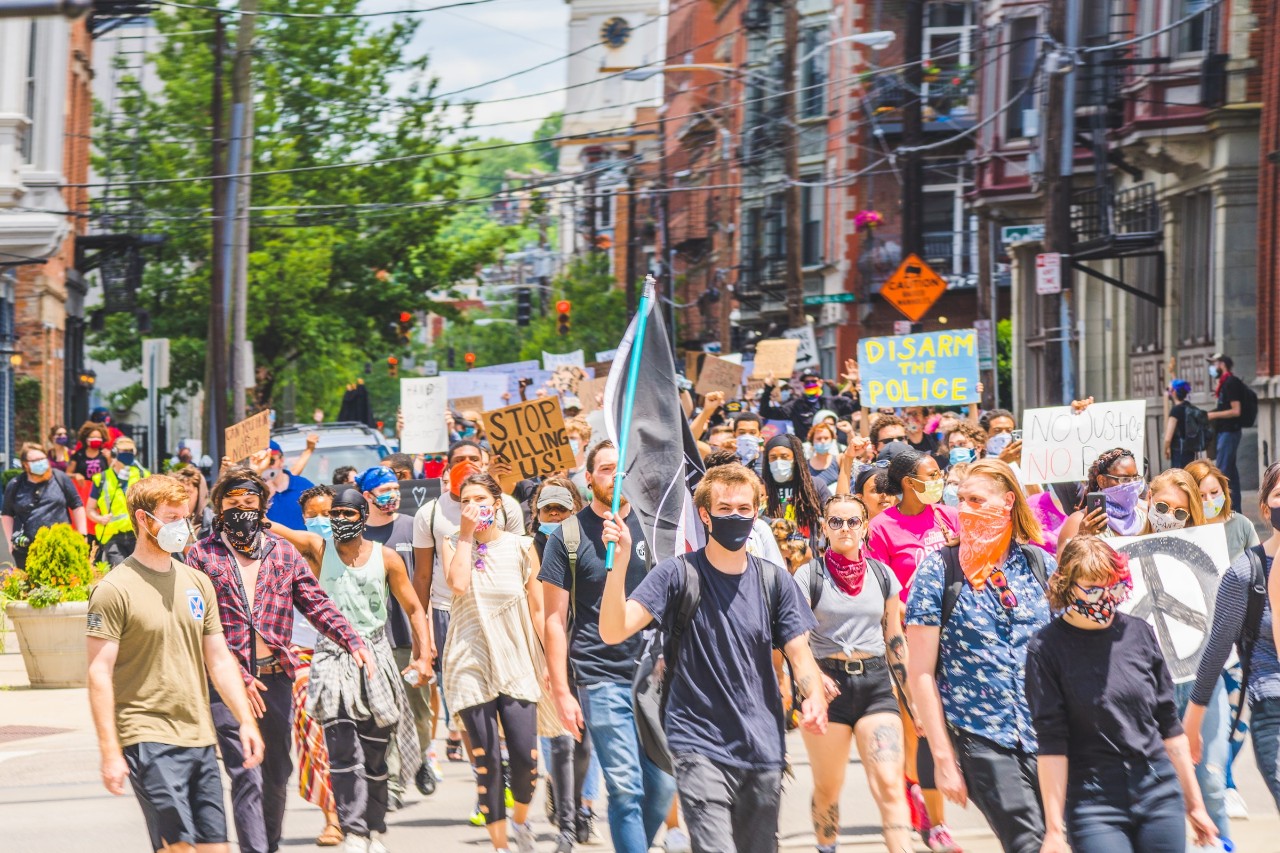 Protesters taking to the streets holding flags and banners