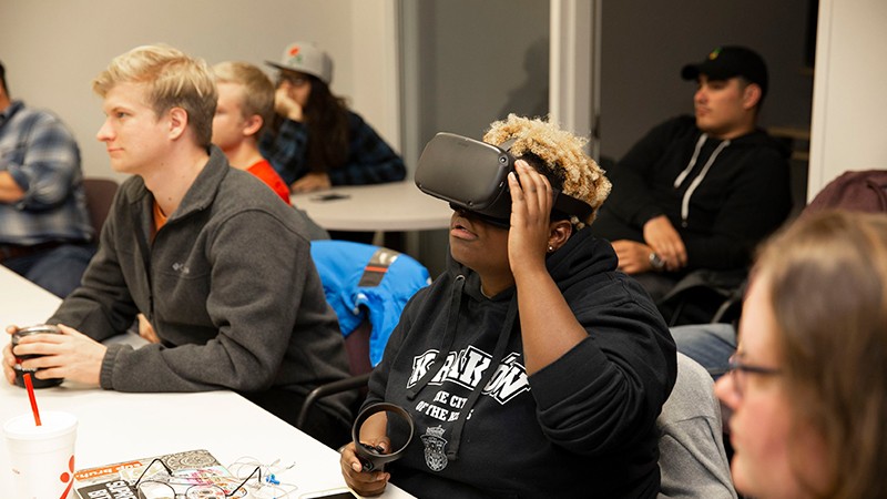CCM E-Media student Kela Parker uses the virtual reality headset and hand sensor for the "Hope After Hate" project